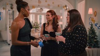 Heather Headley as Helen Decatur, JoAnna Garcia Swisher as Maddie Townsend and Brooke Elliott as Dana Sue Sullivan wearing formal dresses drinking cocktails while decorating a holiday party in sweet magnolias season 4