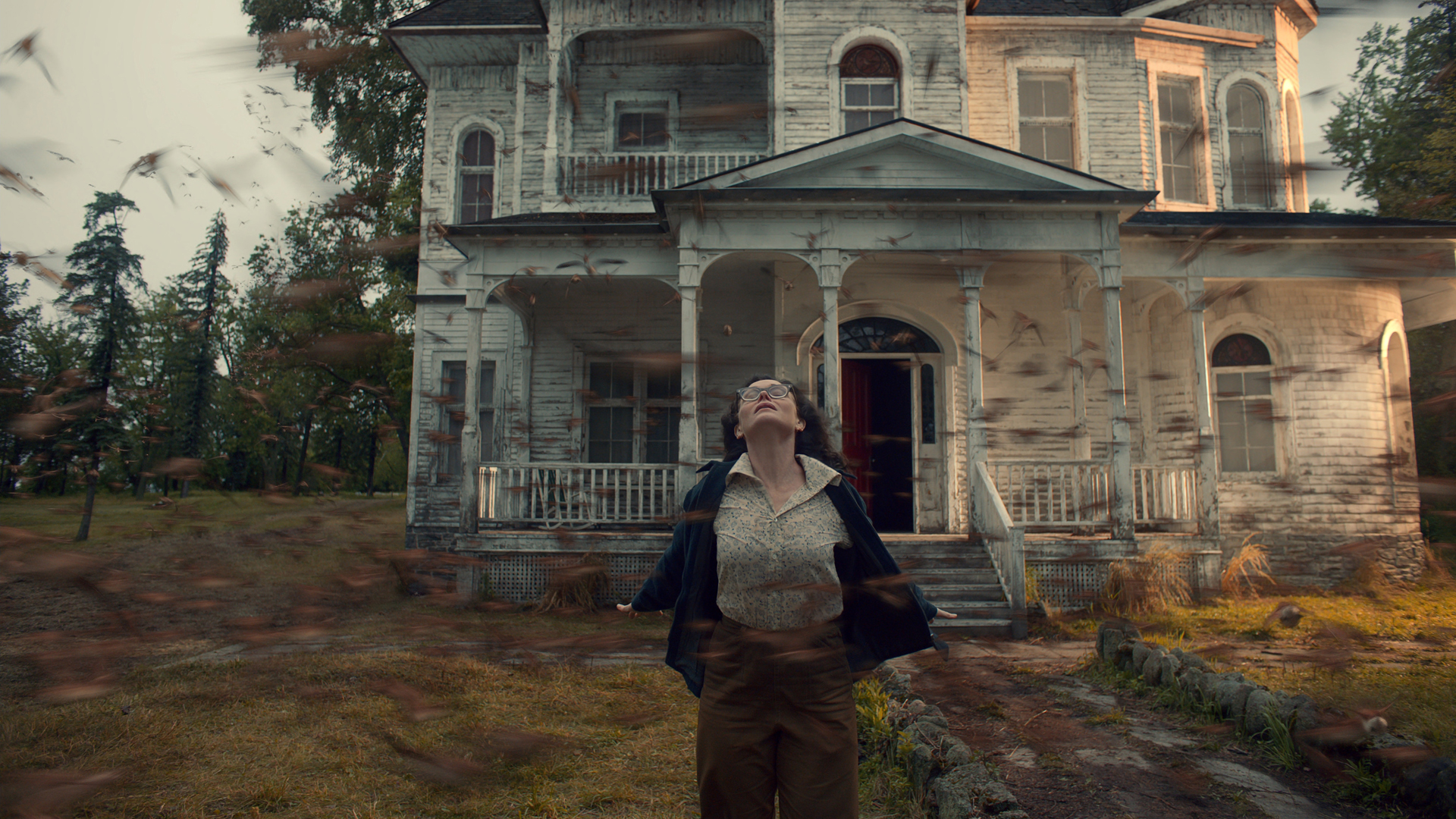 Nancy Bradley stands outside her house as a fierce wind hits her in The Murmuring on Netflix