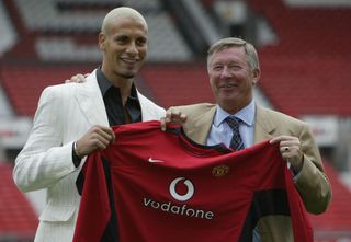 Rio Ferdinand poses next to Sir Alex Ferguson after signing for Manchester United in 2002.