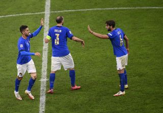 Lorenzo Pellegrini, left, celebrates scoring