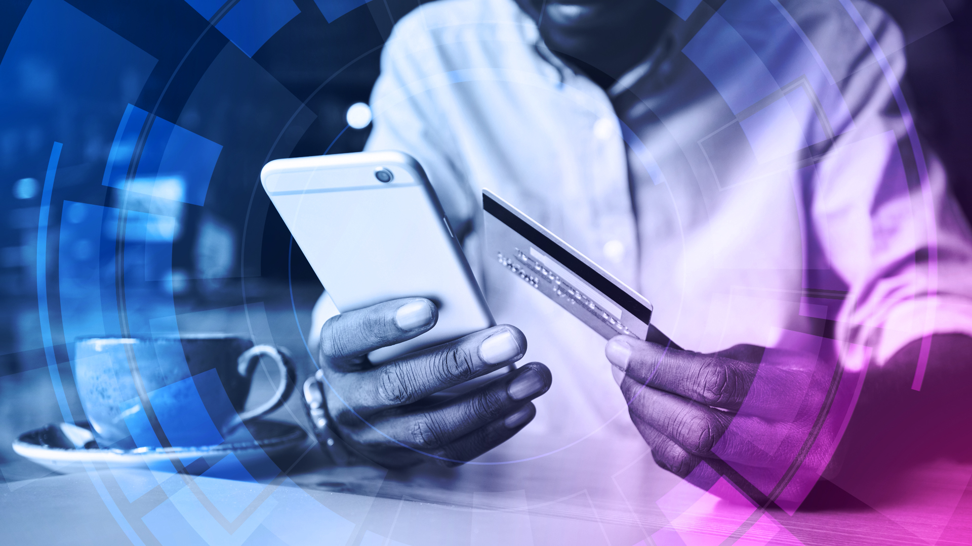 A man holding a credit card next to a mobile phone