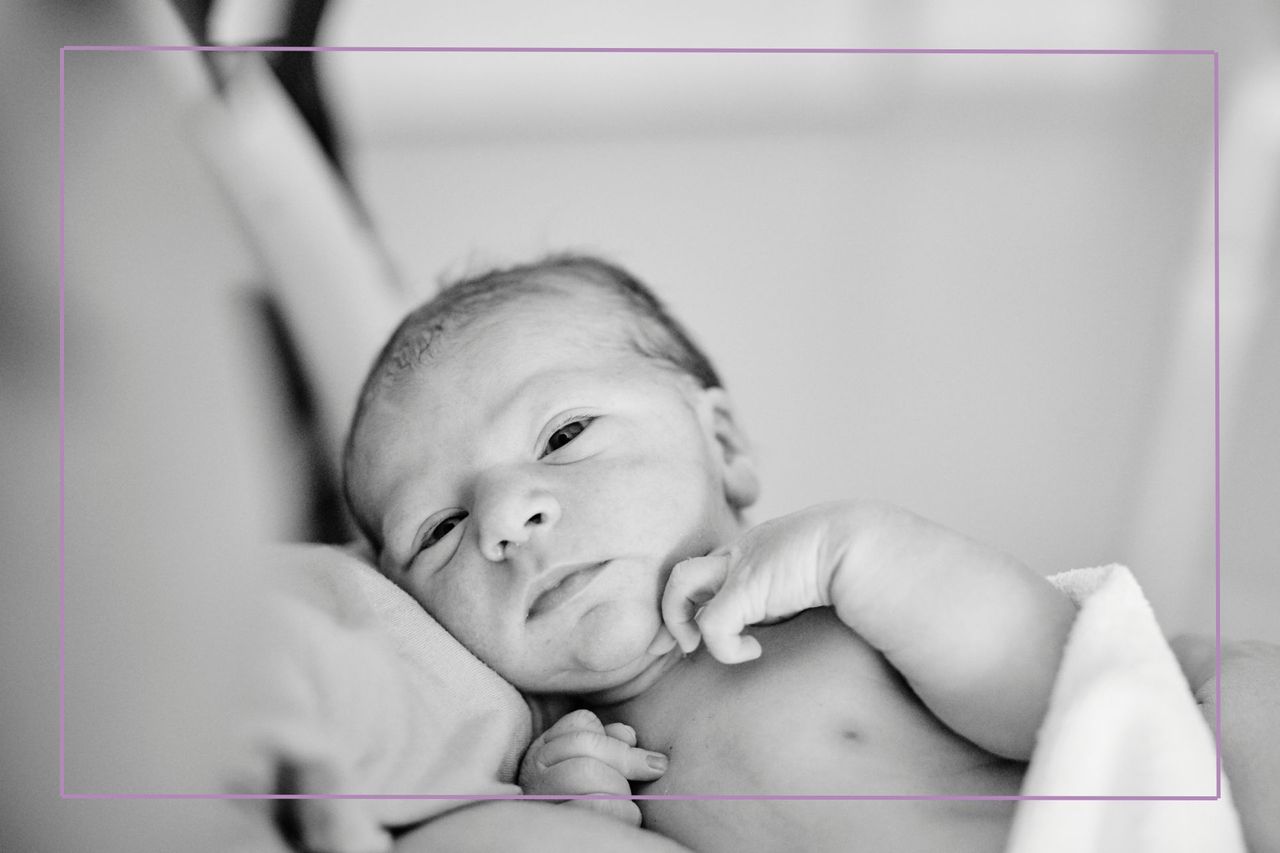 Black and w hite image of baby looking at camera