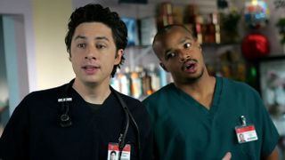 zach braff and donald faison wearing their scrubs in a hospital on scrubs