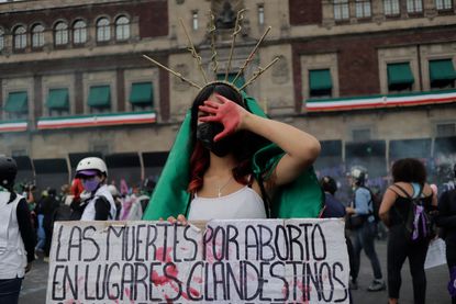 A woman dressed as the Virgin of Guadalupe demonstrates in front of the National Palace in the Zocalo in Mexico City on the occasion of the International Day of Global Action in favour of legal, free and safe abortion in Mexico and Latin America
