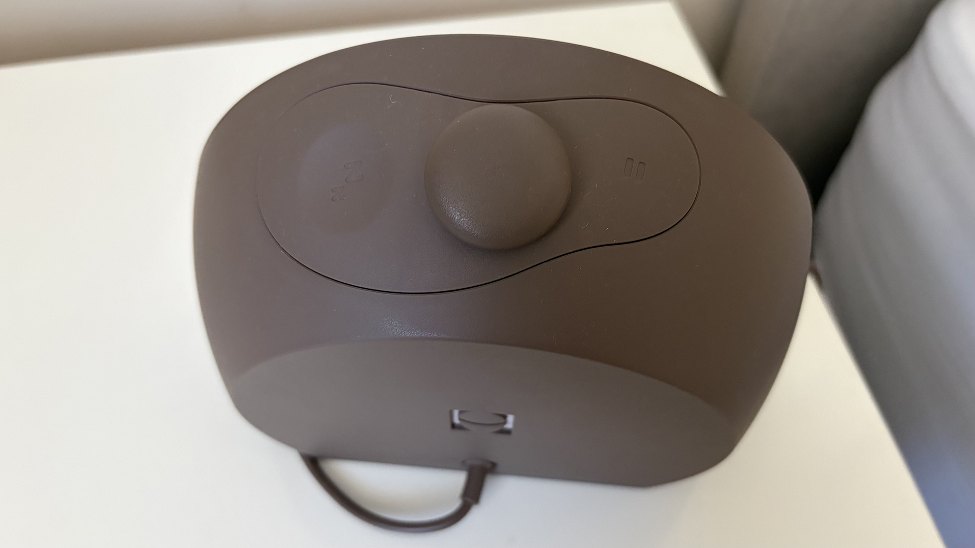 A close up of the back of the Hatch Sleep Clock on our reviewer's nightstand.