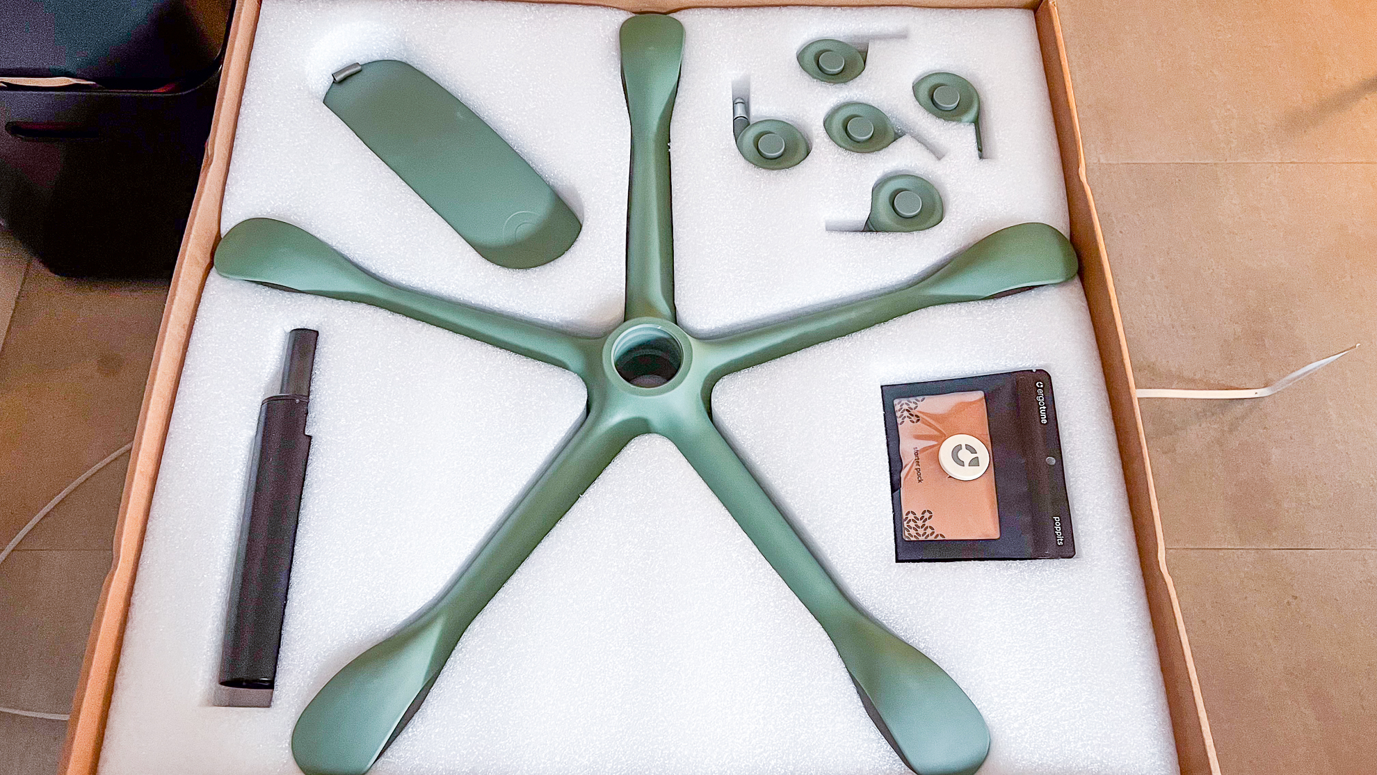 Parts of the base of the ErgoTune Vesby office chair inside a packaging box