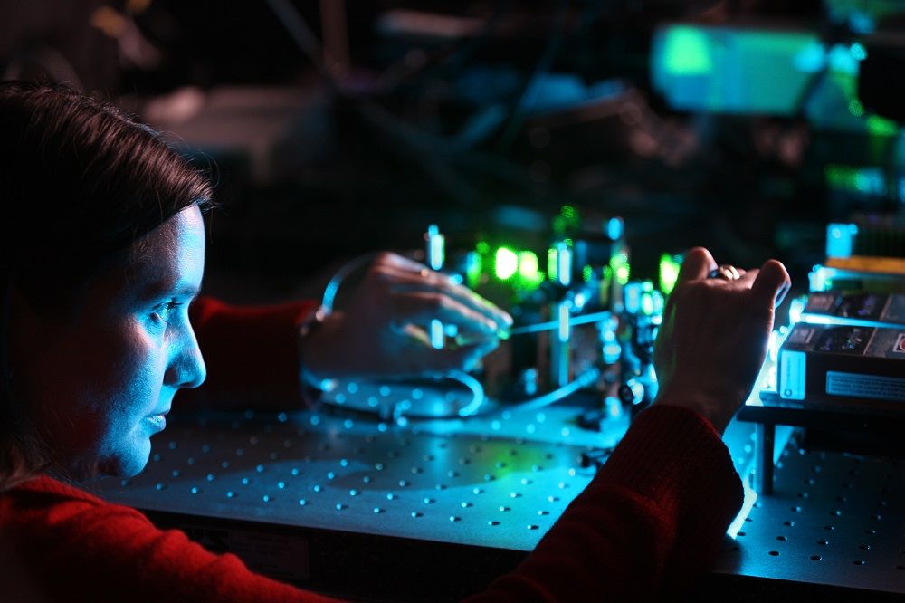 A scientist is working with equipment.