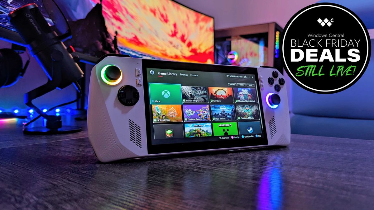 The original ASUS ROG Ally in white, stood straight on a desk with the ASUS Armoury Crate app open, showing a variety of Xbox games and launchers.