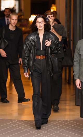 Bella Hadid leaves her hotel at Paris Fashion Week wearing a black aviator jacket and a wide belt