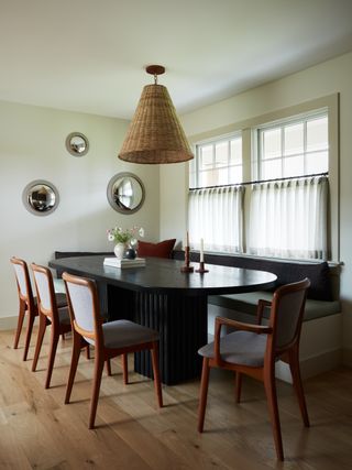 a modern dining room with a rattan ceiling light