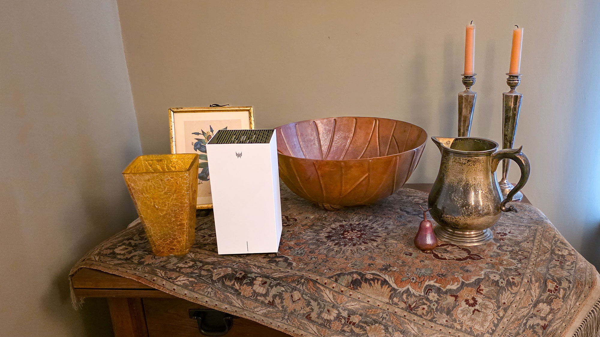 An Acer Predator Connect T7 Wi-Fi 7 gaming mesh router on a table next to a bowl and other items.