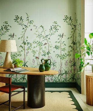 home office design ideas, home office with green floral mural, coir rug, oval desk and chair, lamp,