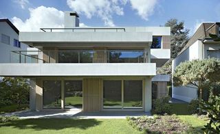 The offset concrete layers result in terraces around the house