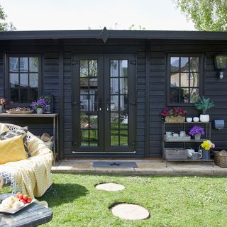black painted garden summerhouse with doors and windows