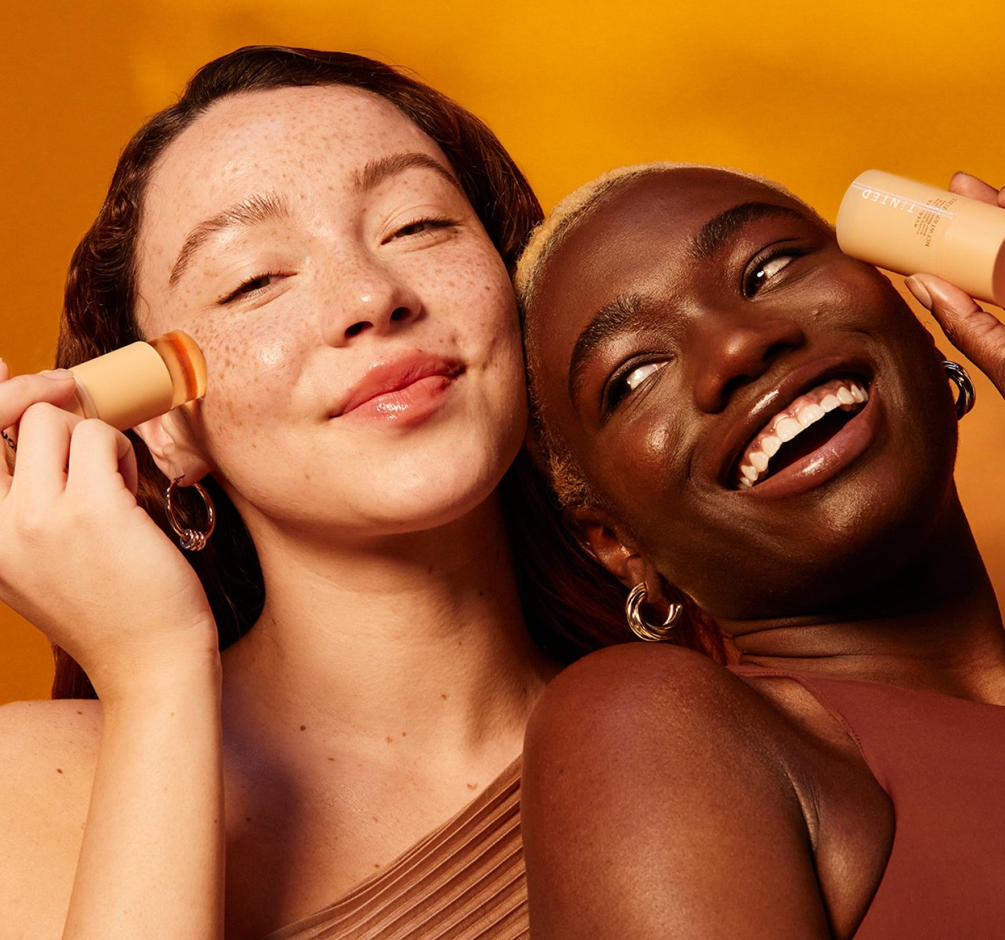 women smiling and holding Live Tinted products