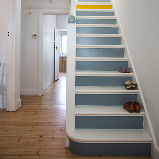 hallway with white staircase and wooden flooring
