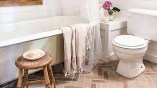 Rustic bathroom with brick floor tiles