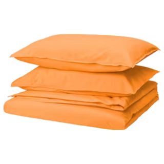 bright orange duvet and pillows in a pile