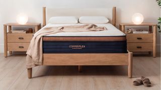 Brooklyn Bedding CopperFlex mattress in bedroom with wooden floor, wooden bed base and two bedside tables