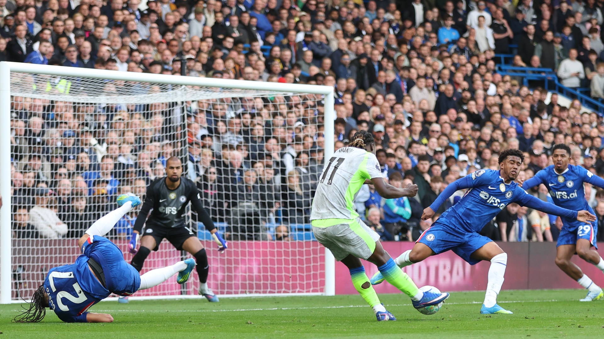 Jeremy Doku taking a shot during a Chelsea vs Man City game