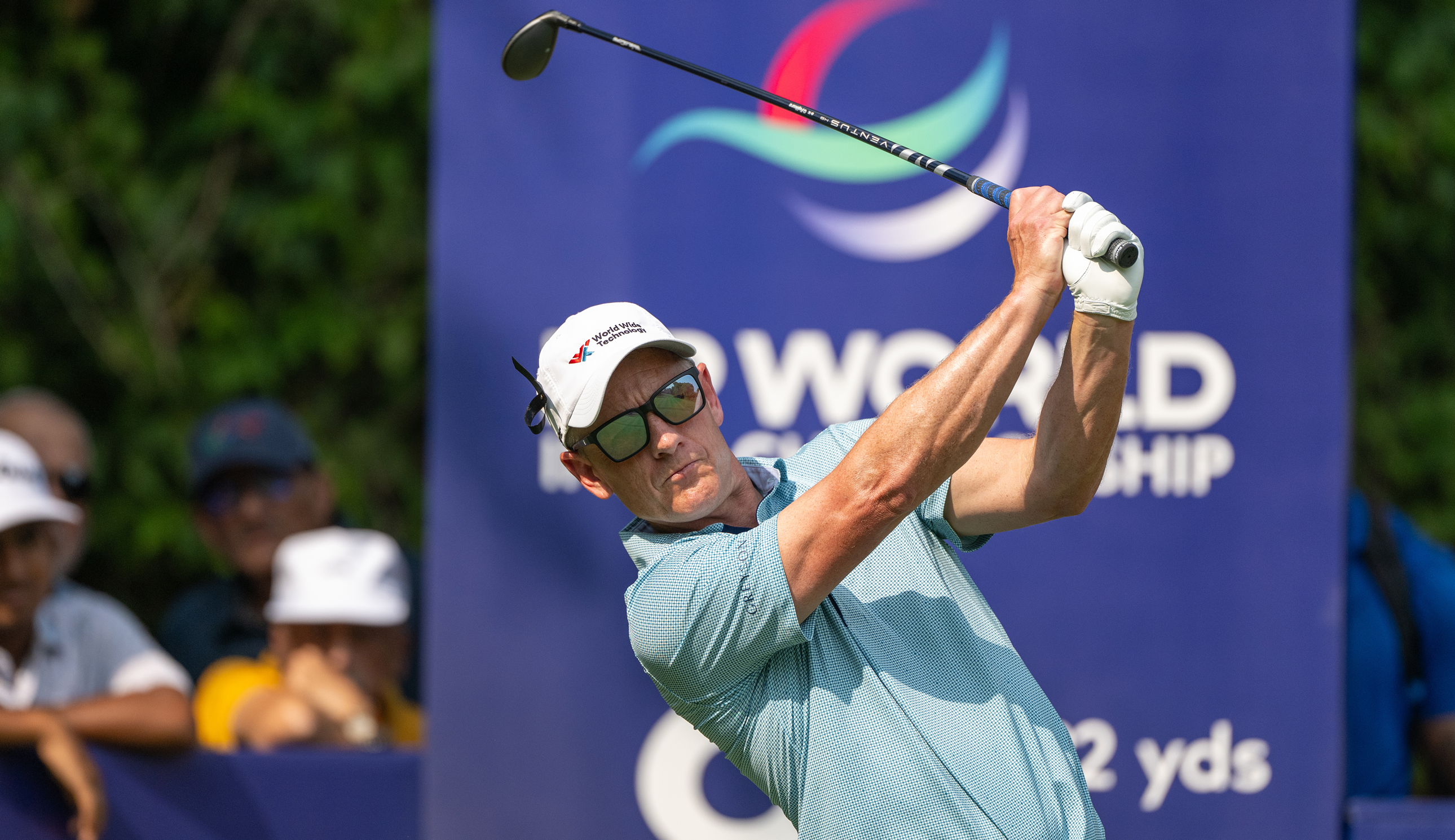 Luke Donald hits an iron shot and watches its flight