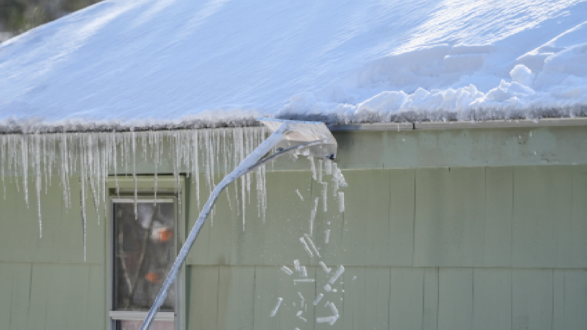 Roof rake on snowy roof