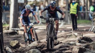 Pidcock charges ahead of Van der Poel over a technical rock section