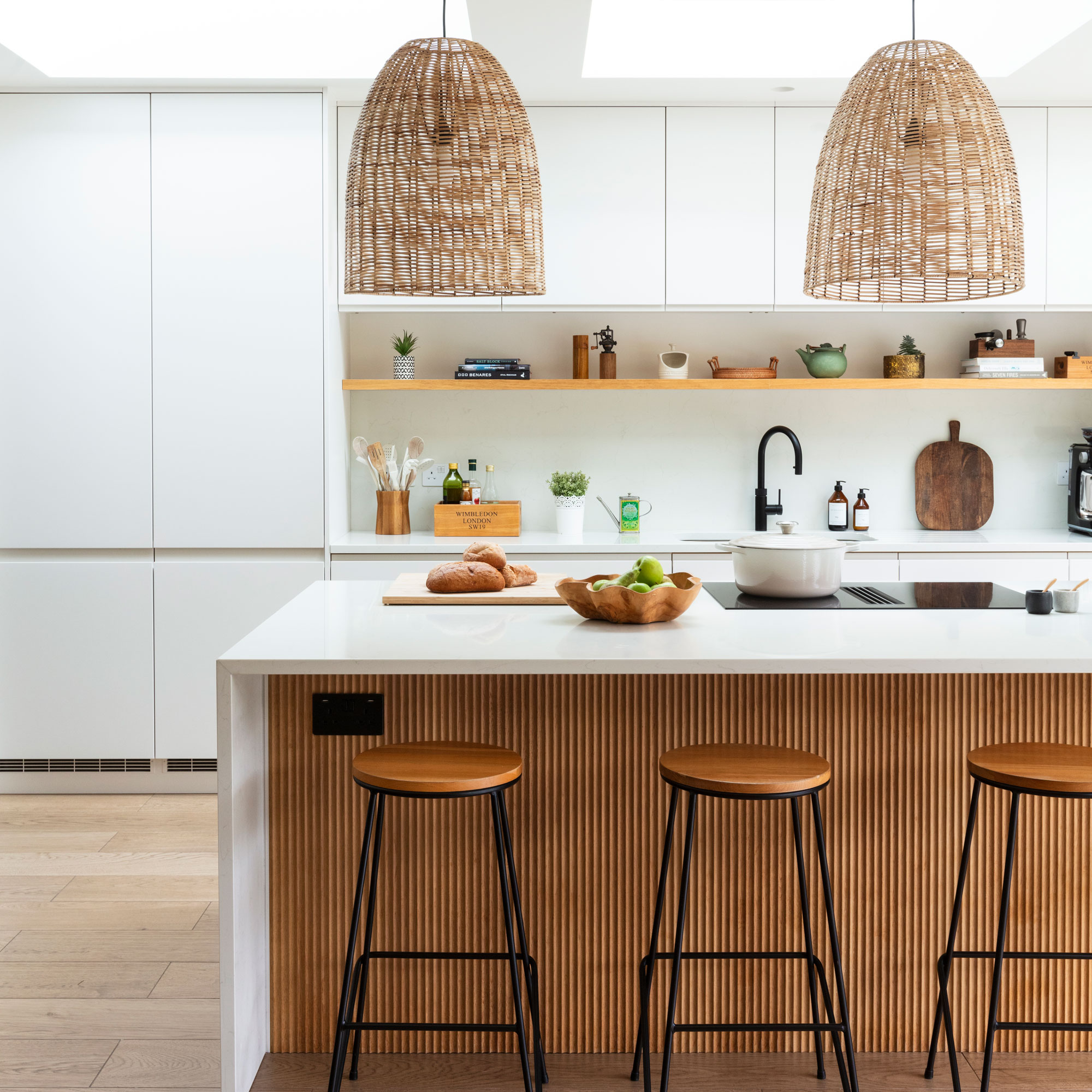 Fluted kitchen island with white cabinets