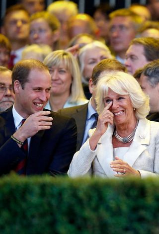 Queen Camilla laughing with Prince William