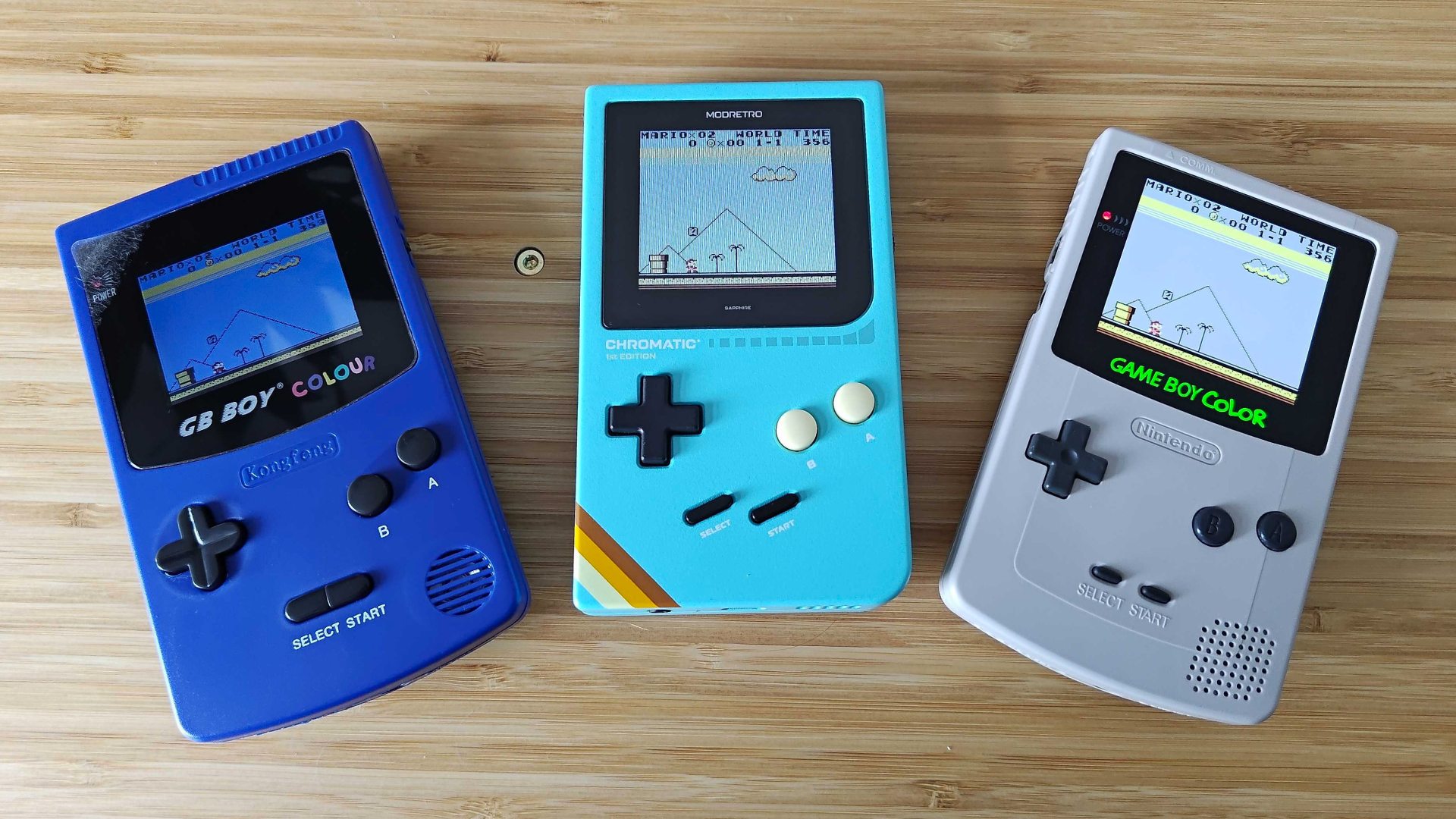 GB Boy Colour, Modretro Chromatic, and AMOLED Game Boy Color running Super Mario Land