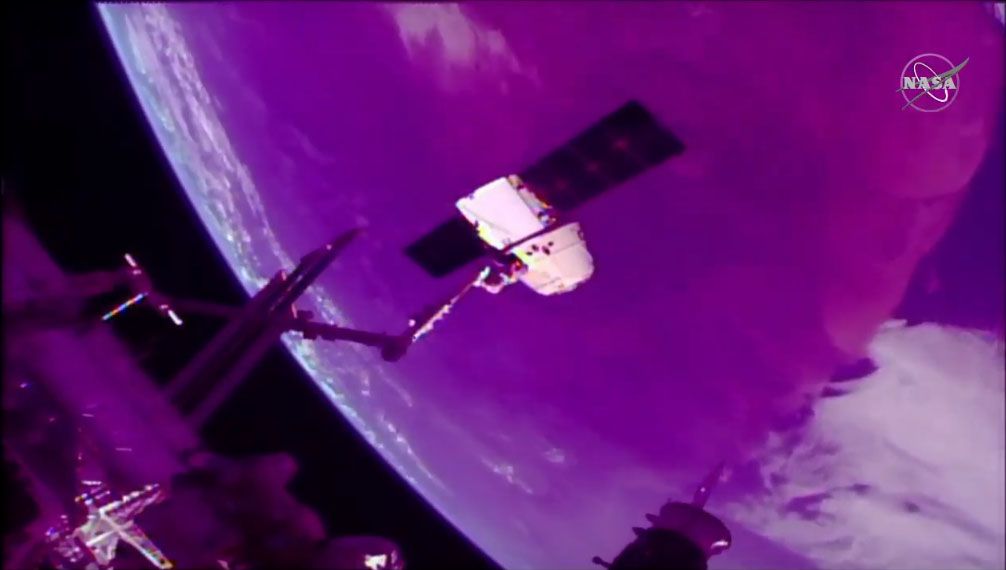 SpaceX&#039;s CRS-18 Dragon cargo ship is seen at the end of the International Space Station&#039;s robotic arm during departure operations on Aug. 27, 2019.