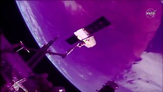 SpaceX's CRS-18 Dragon cargo ship is seen at the end of the International Space Station's robotic arm during departure operations on Aug. 27, 2019.