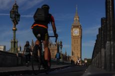 A cyclist commuting towards Big Ben in London