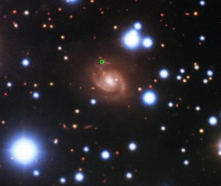 An image of the fast radio burst's host galaxy, acquired with the Gemini-North telescope on Mauna Kea in Hawaii. The position of the FRB in the spiral arm of the galaxy is marked by a green circle.