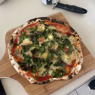 Kale, chard and blue cheese pizza baked on stone with gas pizza oven