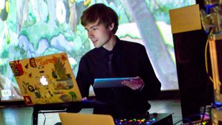 A picture of musician c418 on their laptop