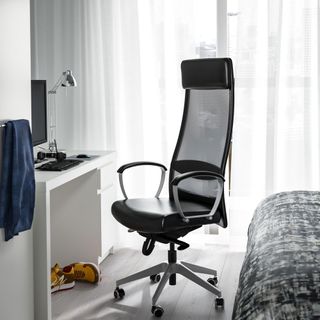Bed room with a large black office chair