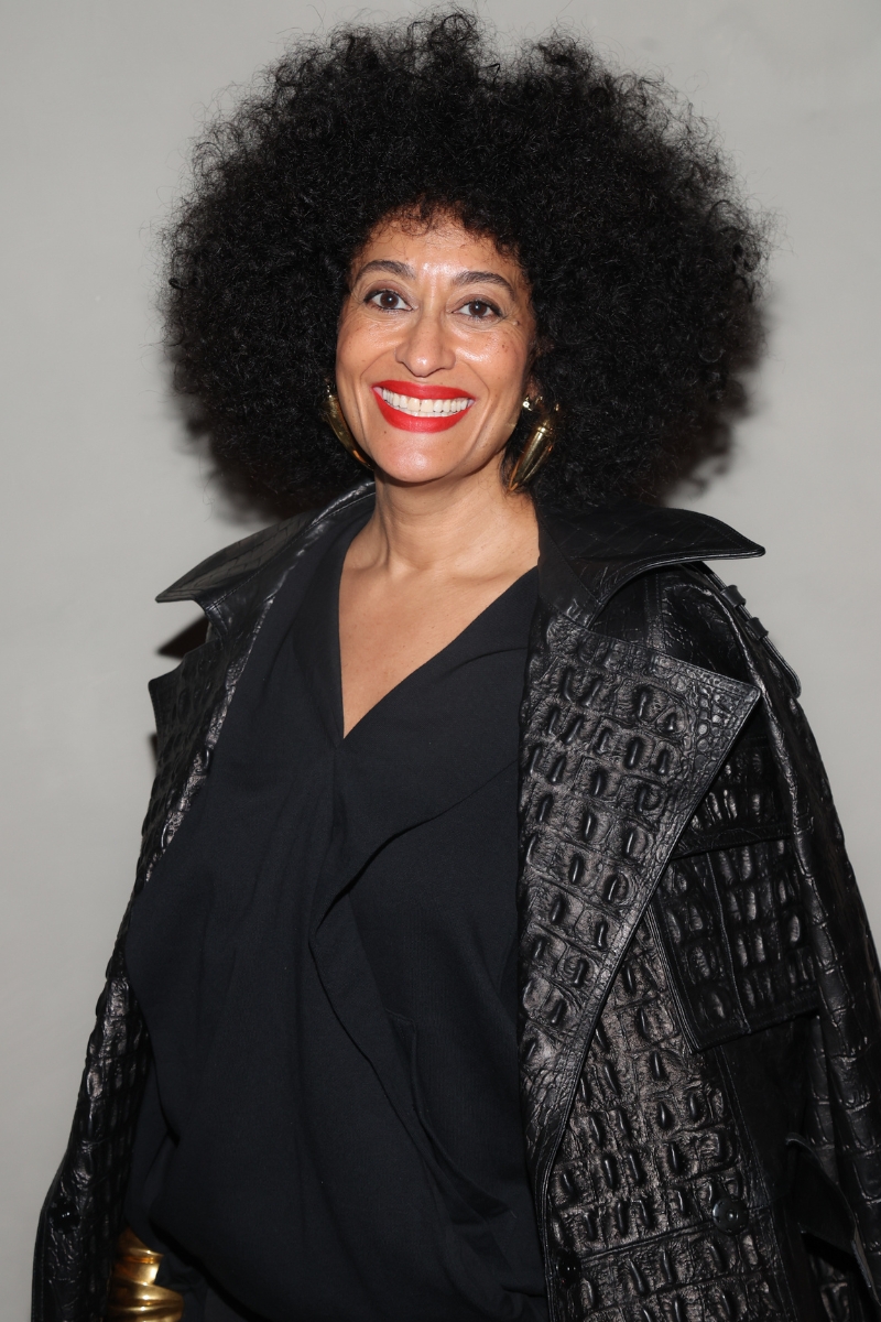 Tracee Ellis Ross is pictured with soft, voluminous curls in an afro-style, and wearing a black dress and textured leather-look coat at the Black Hair Reimagined - The New Era of Beauty Hair Show on May 02, 2025 in New York City.