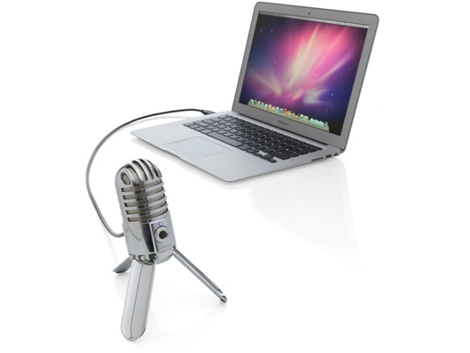 A Samson Meteor mic tries to run away from a MacBook Air.