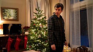 Nathan Fielder stands in a domestic Christmas setting in The Rehearsal