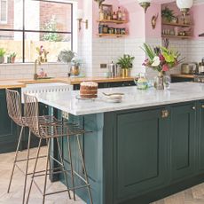 Pink kitchen with green kitchen island