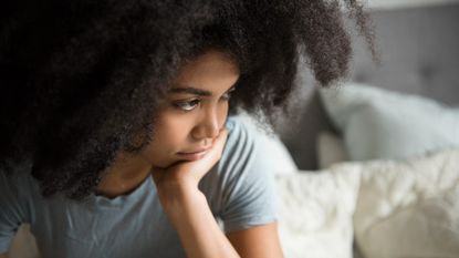 woman sitting in bed - stock photo