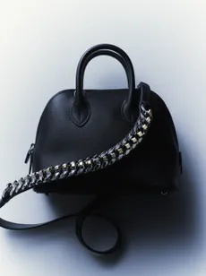 A black Herm&egrave;s bag with a silver chain handle
