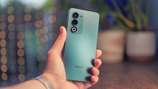 Oppo A5 5G phone held in a hand