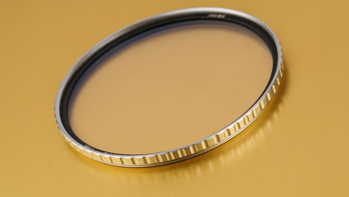 Gold-rimmed NiSi Pro Nano Air UV filter on gold background