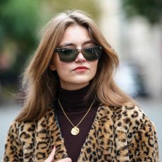 Segolene Hyppolite wears leopard coat and sunglasses with bouncy hair from the best round brushes for blowdrying