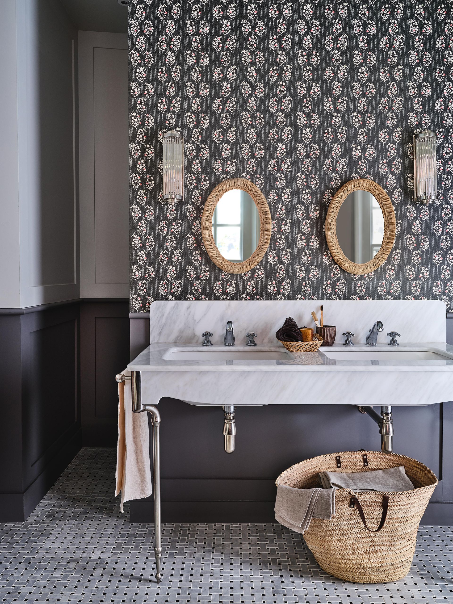 Gray bathroom with wallpaper and a double sink with marble countertop