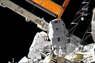 NASA astronauts Frank Rubio (at left) and Josh Cassada (with back to the camera) work to install a mounting frame for a new International Space Station (ISS) Roll Out Solar Array (iROSA) during a spacewalk on Tuesday, Nov. 15, 2022.