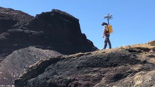 Michael Zanetti, a NASA planetary scientist at NASA’s Marshall Space Flight Center, testing the Kinematic Navigational and Cartography Knapsack (KNaCK) in late 2021. Zanetti was at the Cinder cone in Portillo volcanic field in New Mexico.