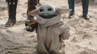 Grogu with a Mandalorian wrist weapon as seen in The Mandalorian season 3